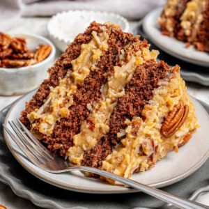 a piece of layered German chocolate cake on a plate