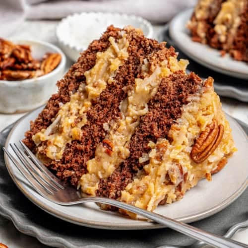 a piece of layered German chocolate cake on a plate