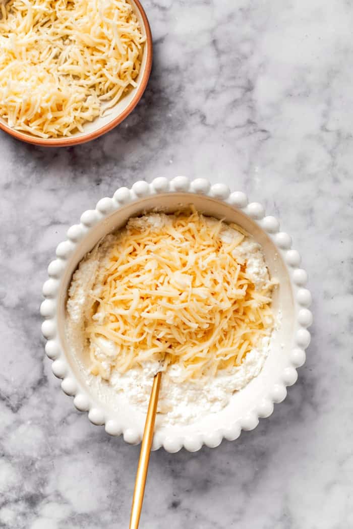 Mixing mozzarella into bowl of cheesy yum