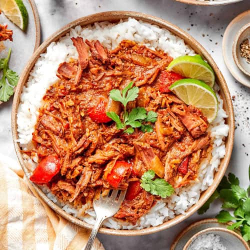 a bowl of rice with shredded beef curry