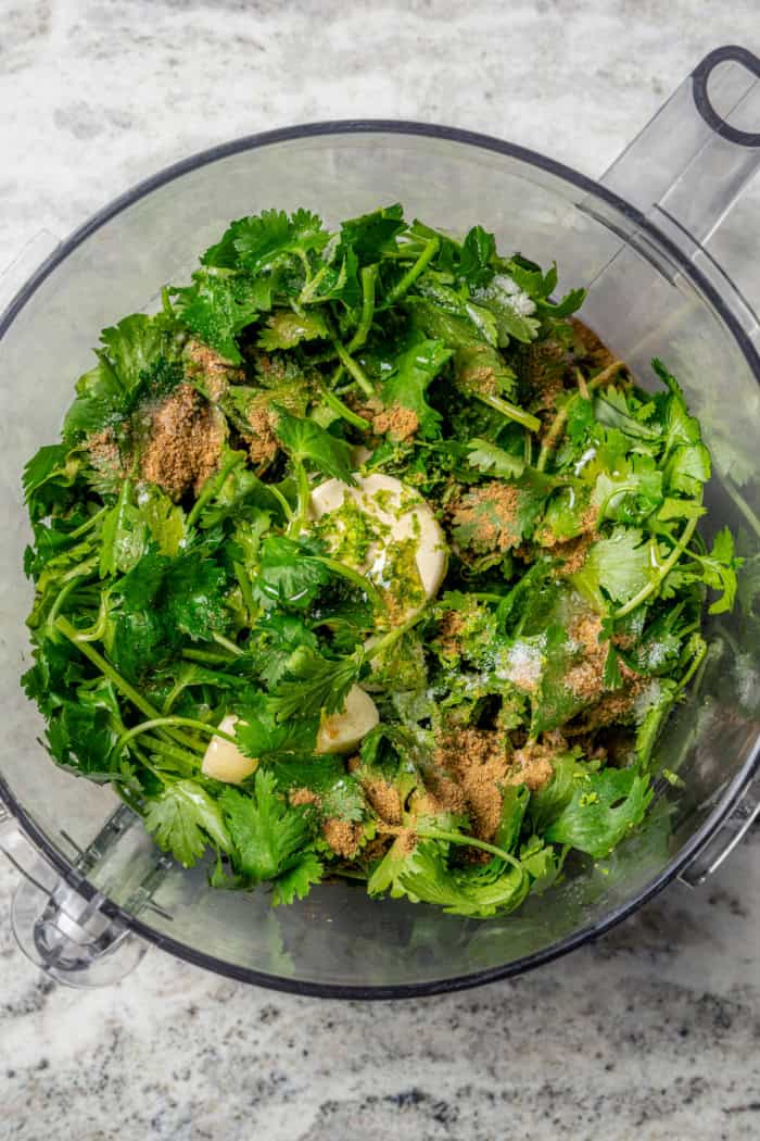Overhead view of ingredients for cilantro lime vinaigrette in food processor