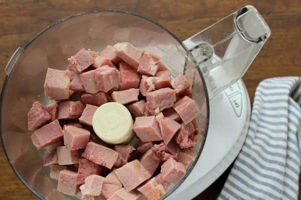 cubes of ham in a food processor bowl
