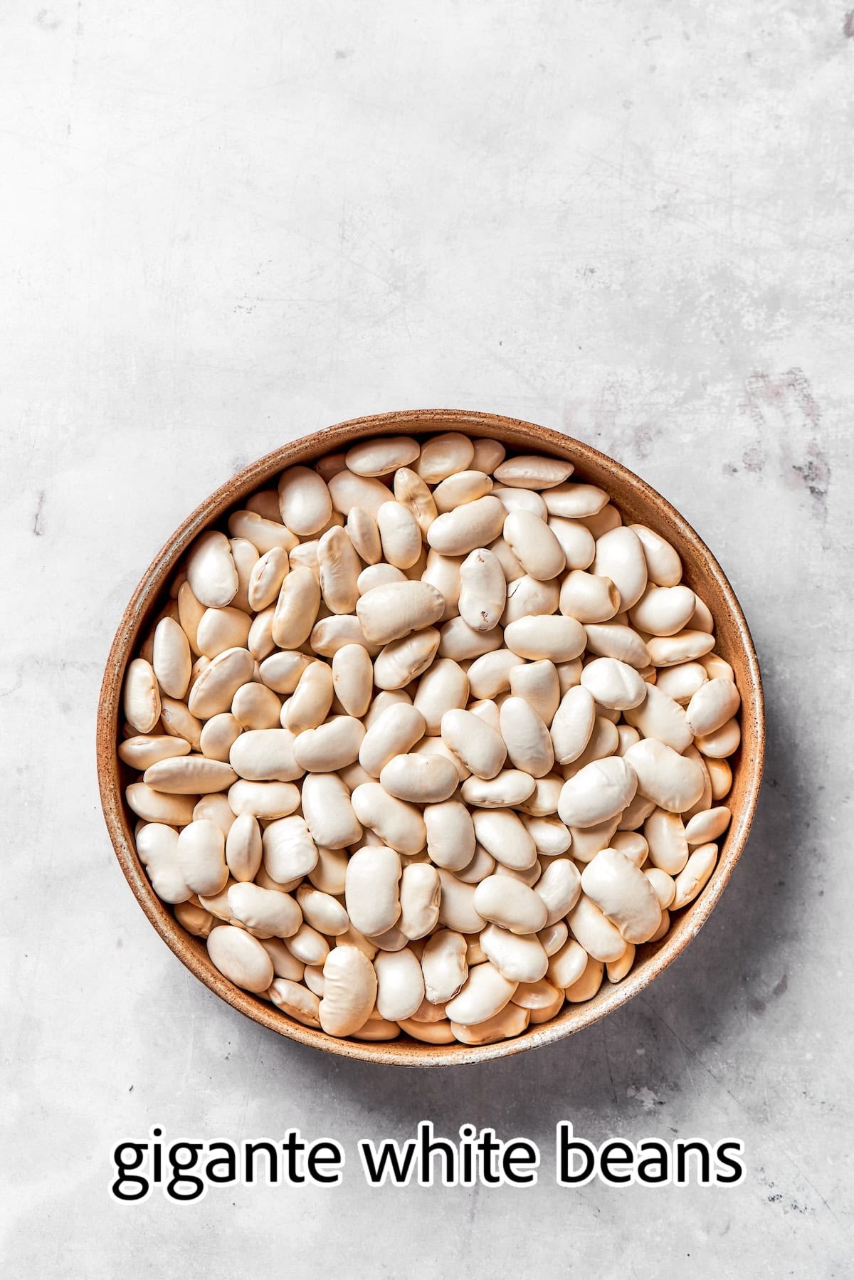 a bowl of uncooked gigante white beans