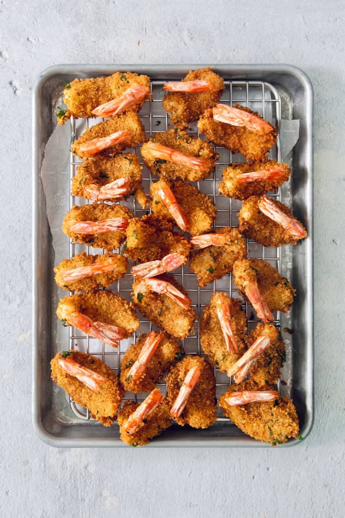 Overhead view of butterfly shrimp draining after frying