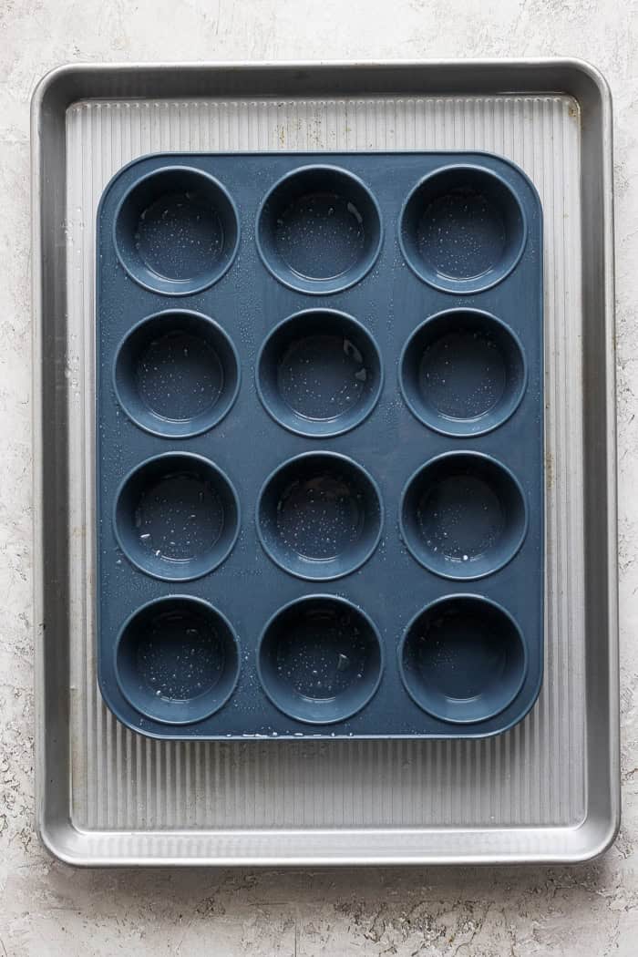 Overhead view of silicone muffin pan coated with oil