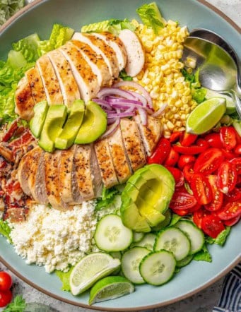 overhead photo of grilled chicken salad on a blue serving platter