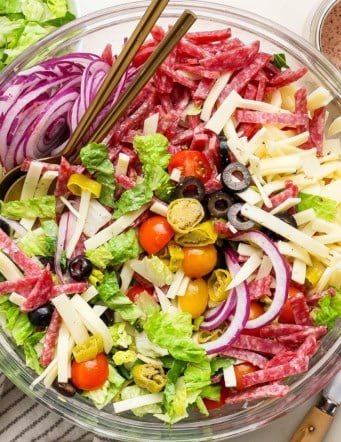 overhead photo of Italian chopped salad in a clear serving bowl