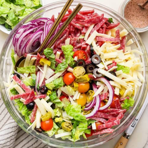 overhead photo of Italian chopped salad in a clear serving bowl