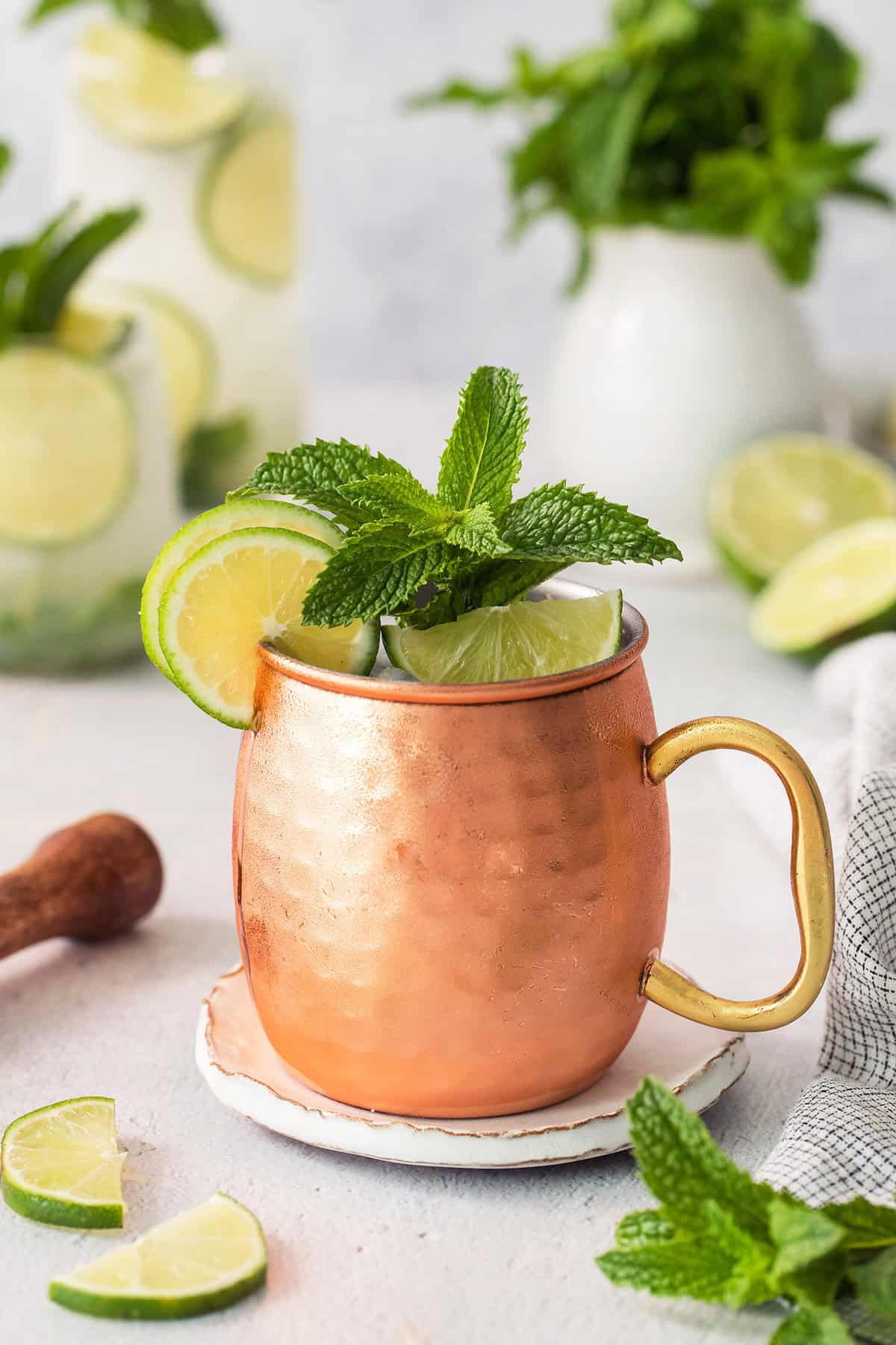 Copper mug with Moscow mule mocktail garnished with fresh lime and mint
