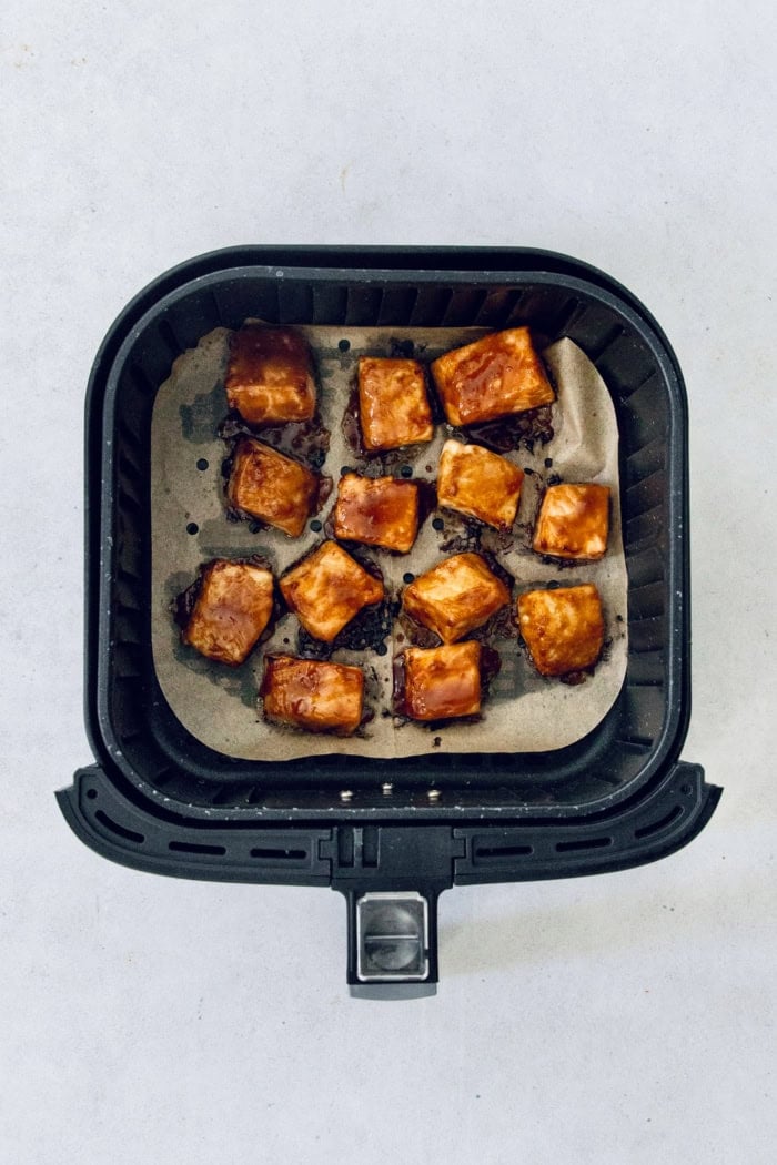 Overhead view of teriyaki salmon bites in air fryer