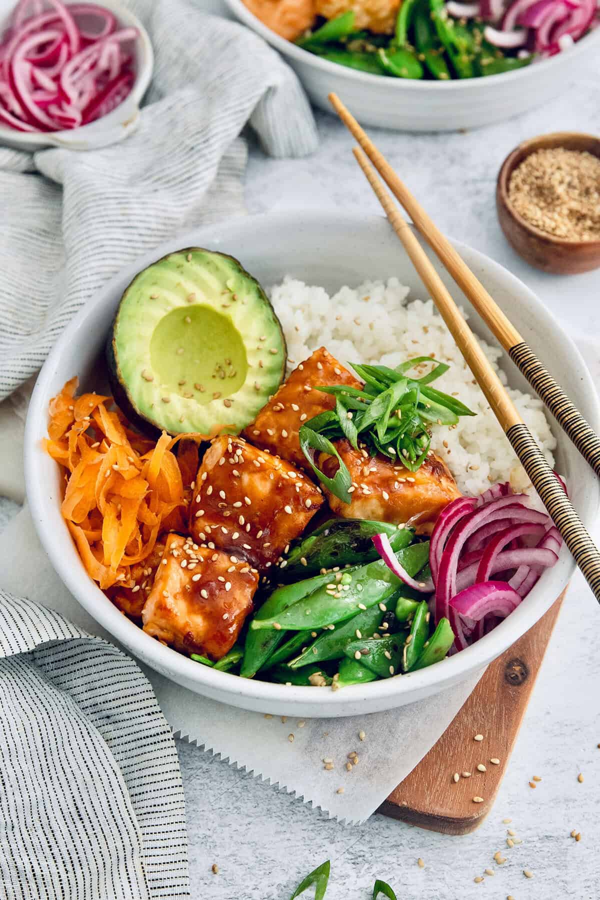 Teriyaki salmon bowl with chopsticks set on top