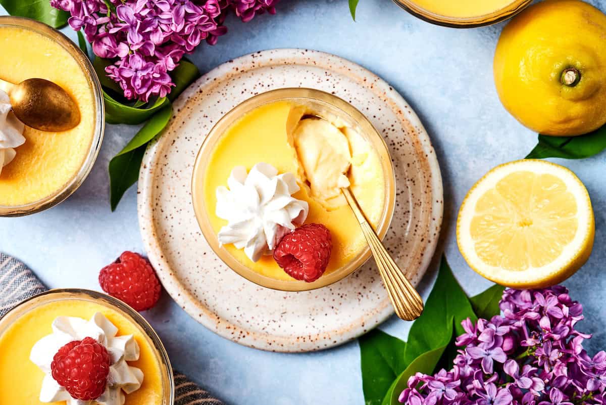 a spoon dipping into a mini lemon custard cup