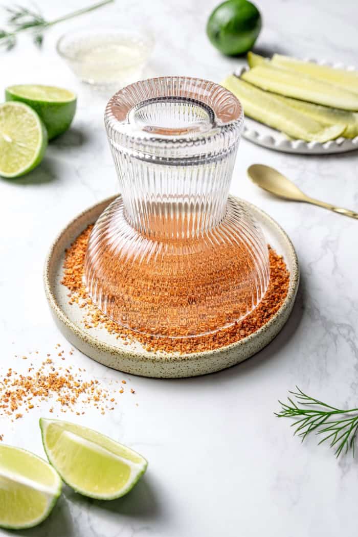 Dipping margarita glass in plate with Tajin