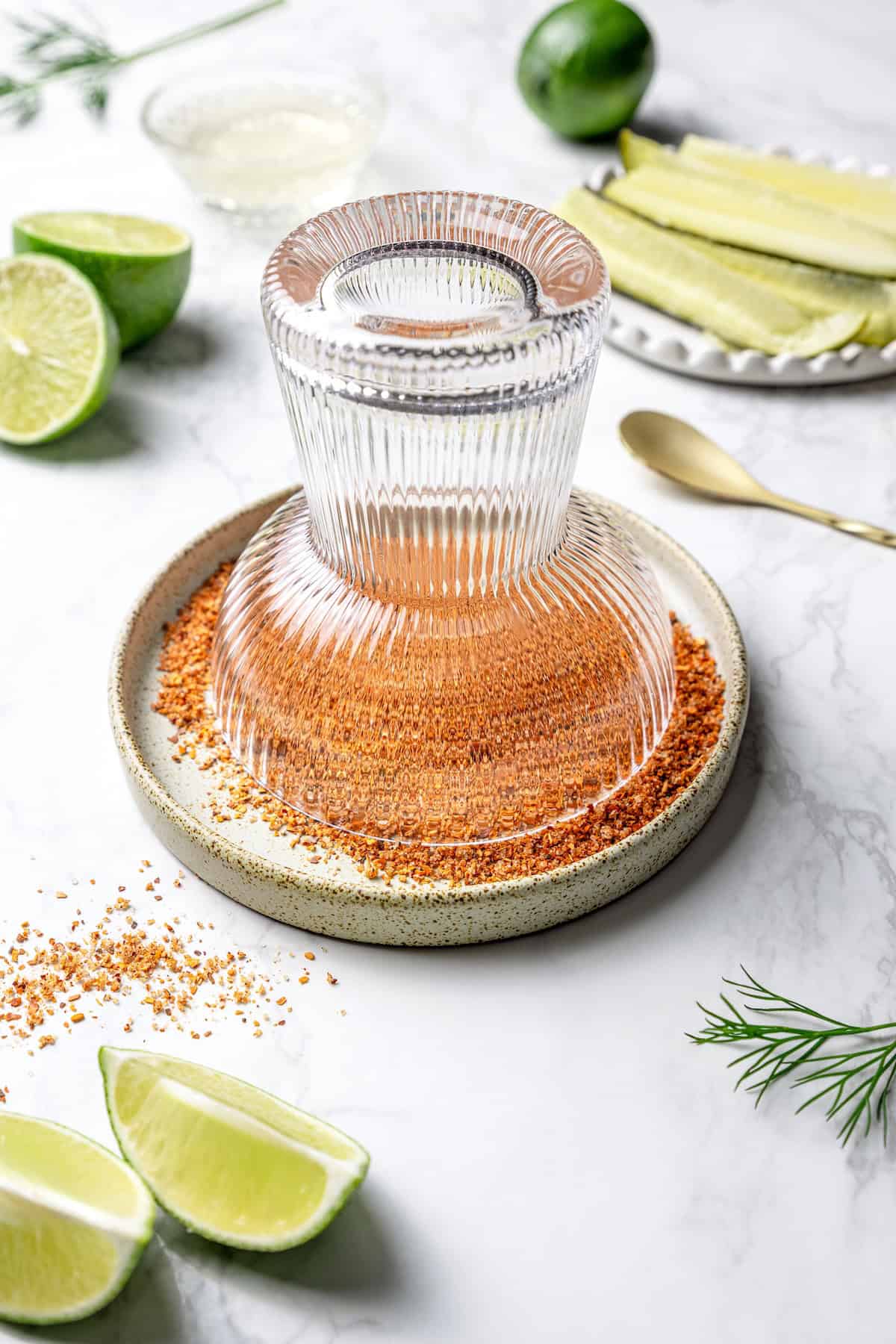 Dipping margarita glass in plate with Tajin