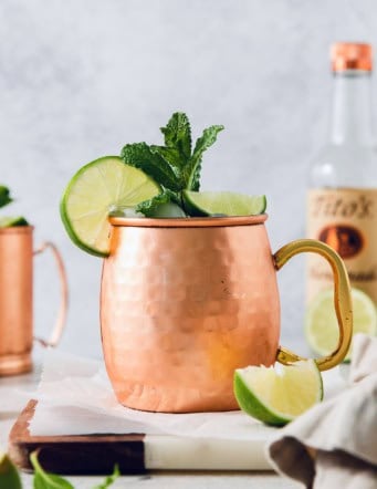 Moscow mule in copper mug with sprig of mint and fresh lime