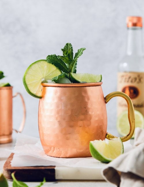 Moscow mule in copper mug with sprig of mint and fresh lime