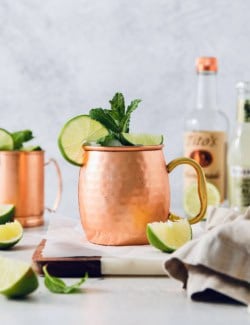 Moscow mule in copper mug with sprig of mint and fresh lime
