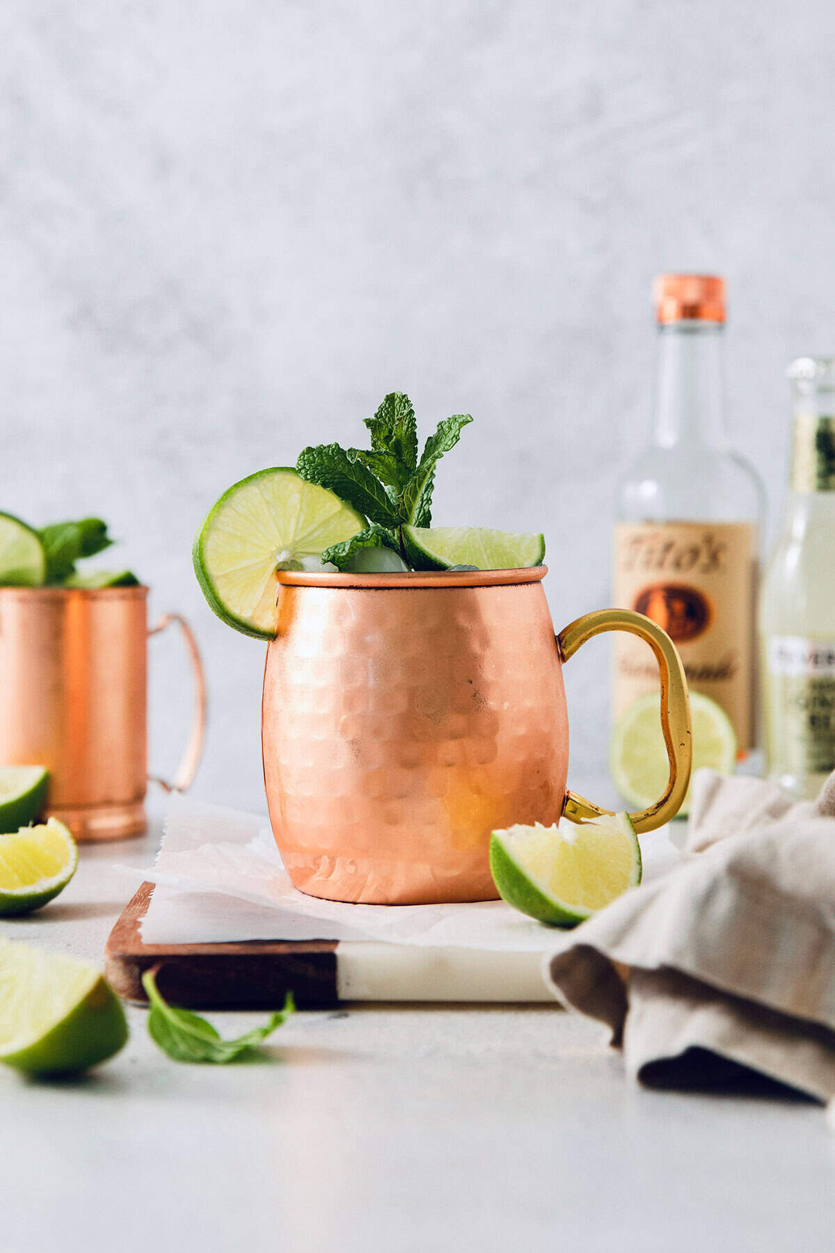 Moscow mule in copper mug with sprig of mint and fresh lime