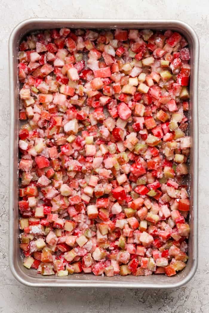 Overhead view of rhubarb dump cake filling in pan