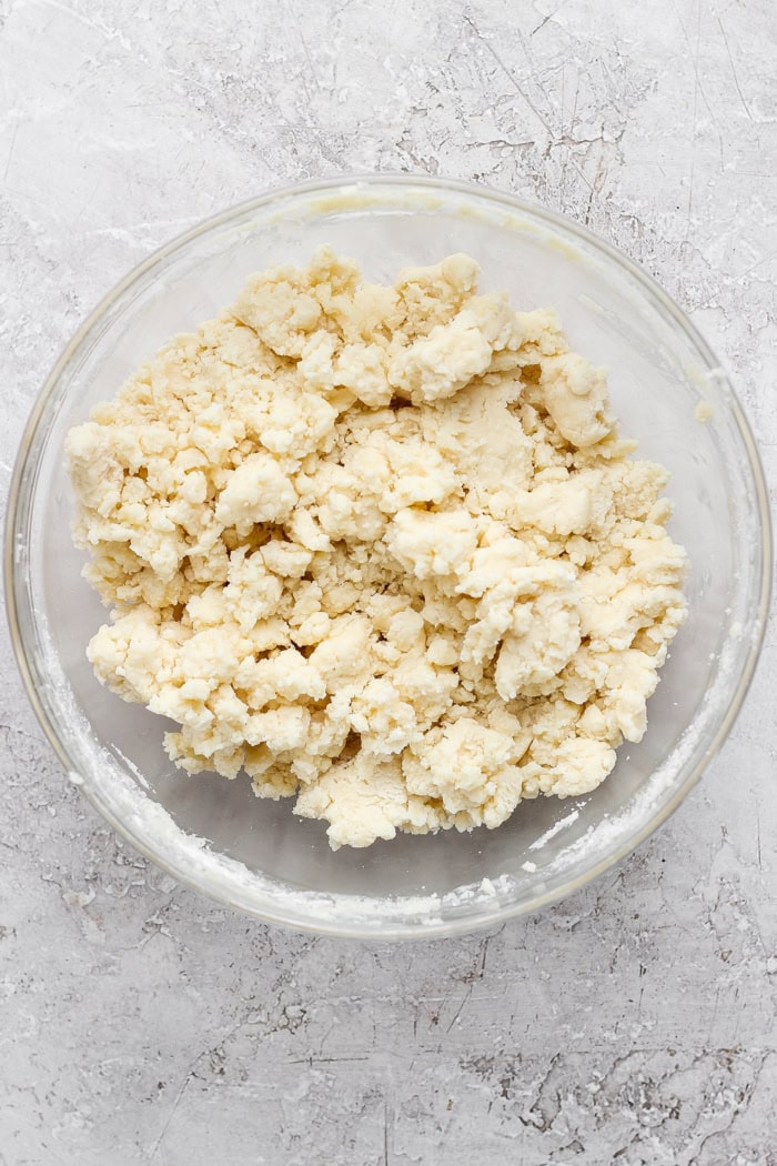 Overhead view of cake batter topping in glass mixing bowl