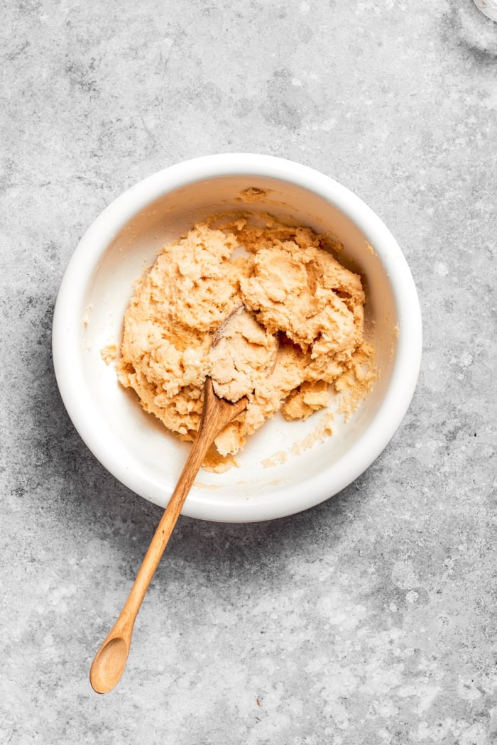 Apple Cobbler has apple pie flavor in an easier form, swapping the crust for a biscuit-like topping that bakes up tender and golden brown! Overhead view of topping for apple cobbler