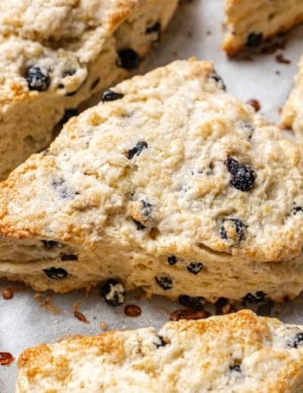 baked blueberry scones on a baking pan lined with parchment