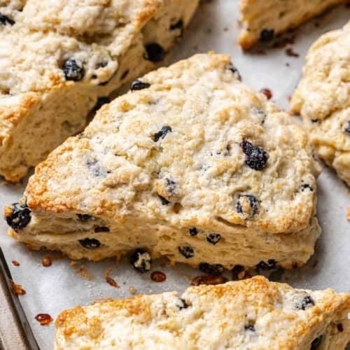 baked blueberry scones on a baking pan lined with parchment