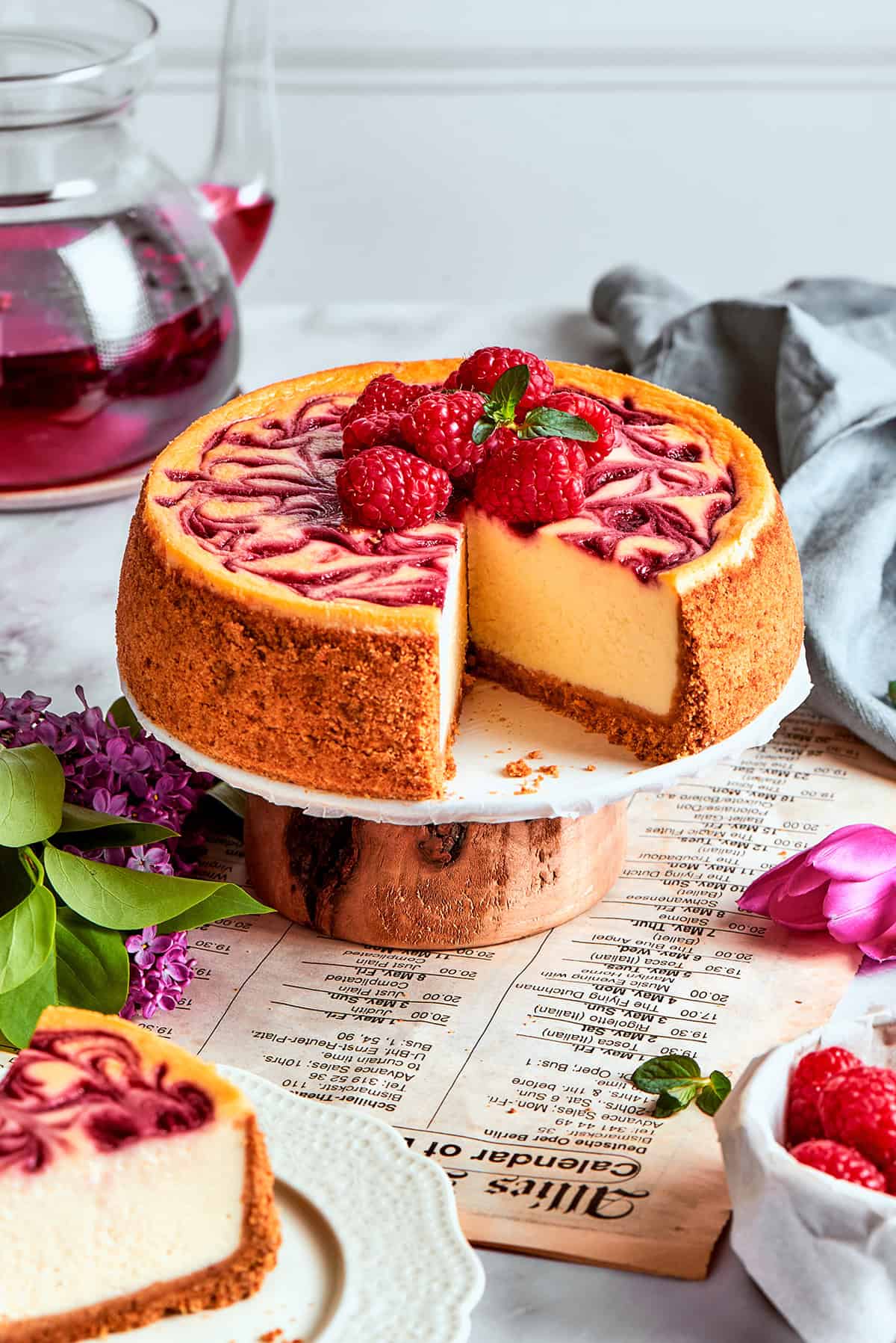 This rich raspberry cheesecake is sure to make your all-time-favorites list. It's rich, creamy, and elegant, but surprisingly easy to make! Raspberry cheesecake on a platter, with a piece removed