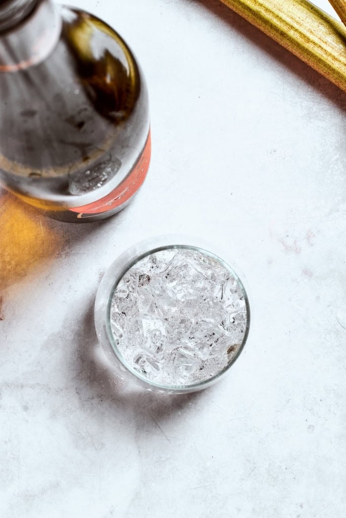 Overhead view of prosecco poured into glass of ice