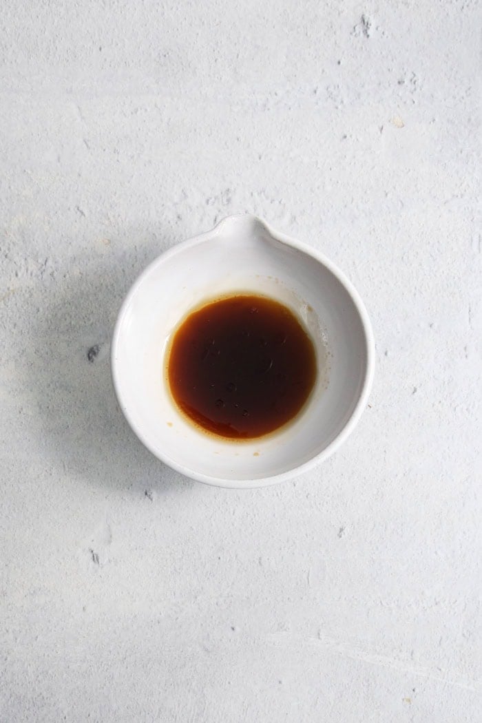 Overhead view of ponzo sauce in small bowl with spout
