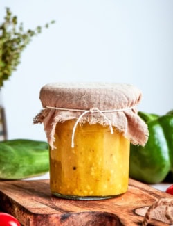 Jar of Greek salad dressing with burlap tied around lid