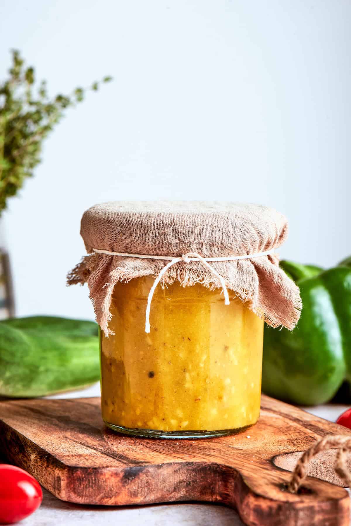 Jar of Greek salad dressing with burlap tied around lid