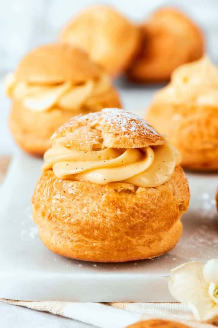 mini cream puffs filled with vanilla pastry cream and dusted with powdered sugar