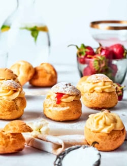 mini cream puffs filled with vanilla pastry cream and fresh strawberry sauce