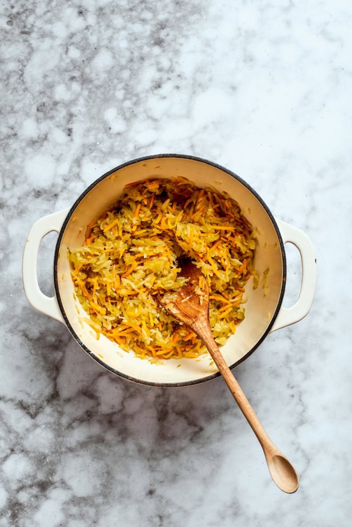 Overhead view of cooked shredded vegetables in pot