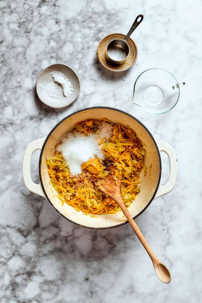 Salt and mustard added to pot of relish