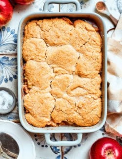 overhead photo of a white rectangular baking dish with baked Apple Cobbler