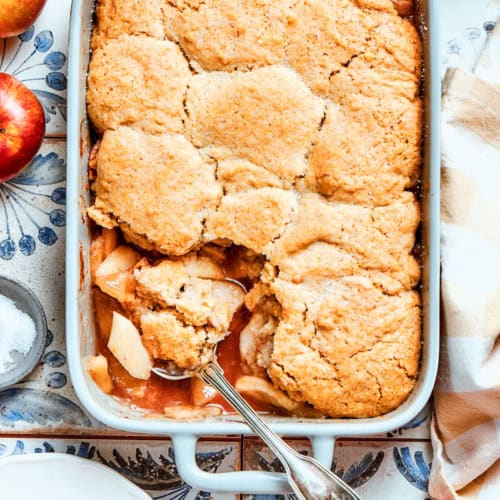 overhead photo of a white rectangular baking dish with baked Apple Cobbler