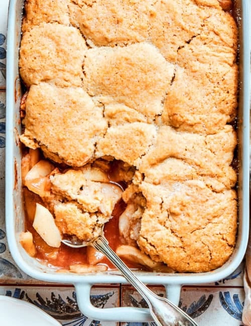 overhead photo of a white rectangular baking dish with baked Apple Cobbler