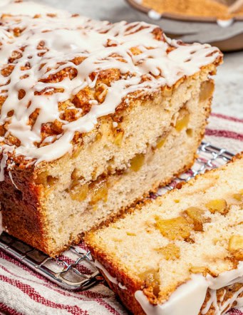 glazed apple fritter bread, sliced to show the fresh apple filling inside
