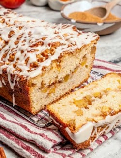 glazed apple fritter bread, sliced to show the fresh apple filling inside
