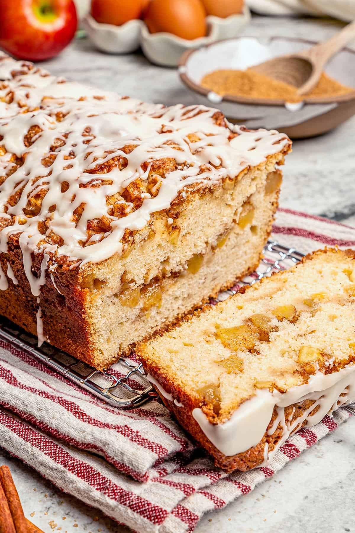 glazed apple fritter bread, sliced to show the fresh apple filling inside