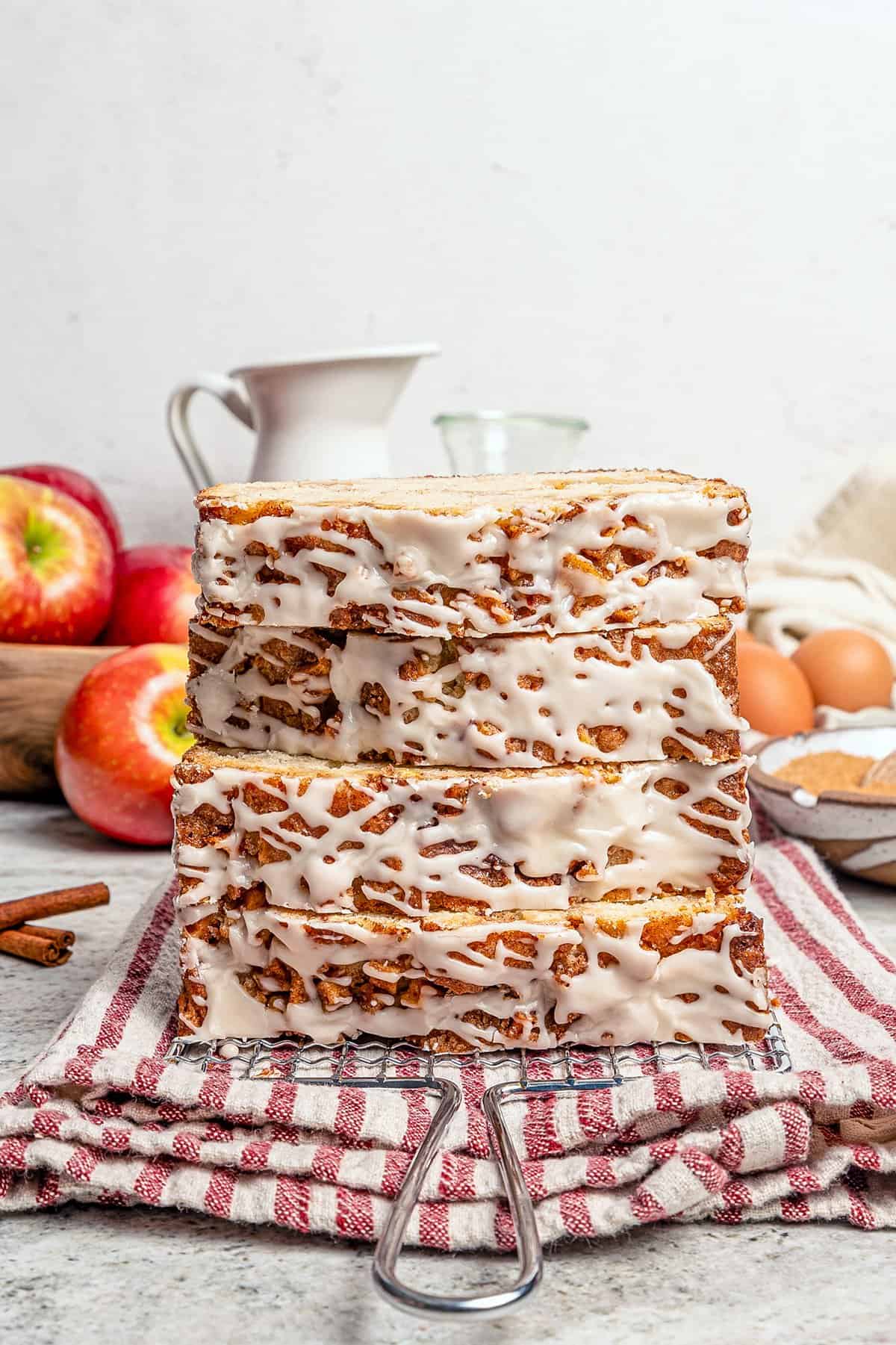 stacked slices of apple fritter bread, showing the glazed topping