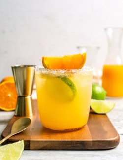 Margarita mocktail on wood board with spoon and jigger