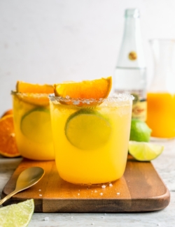 Two margarita mocktails in glasses rimmed with salt