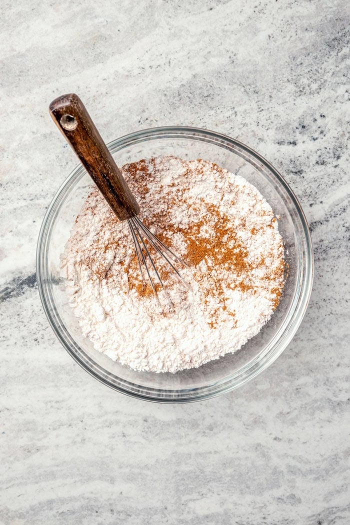 Soft, moist, and chewy, these Pumpkin Chocolate Chip Cookies are the perfect sweet treat for fall! Pumpkin pie spice adds warm, cozy flavor. Whisking dry ingredients in mixing bowl.