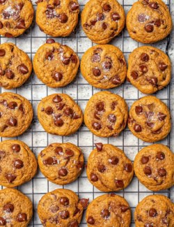Pumpkin chocolate chip cookies on wire rack.