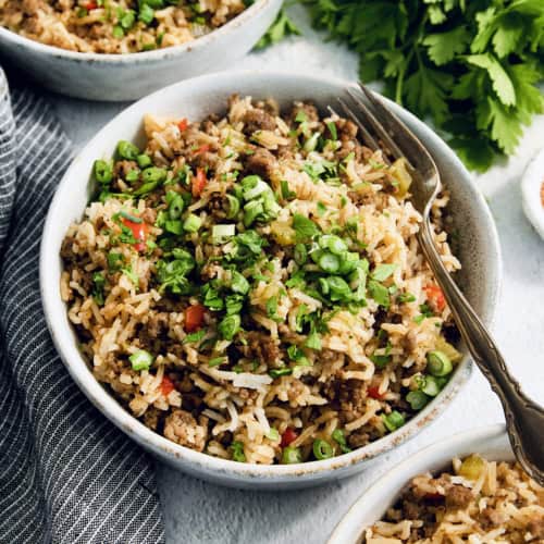 Bowl of dirty rice with fork.