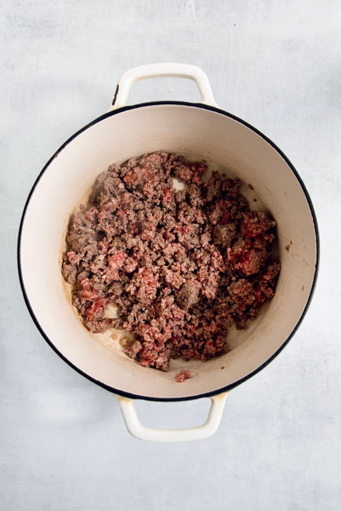 Dutch oven with pork sausage and ground beef.