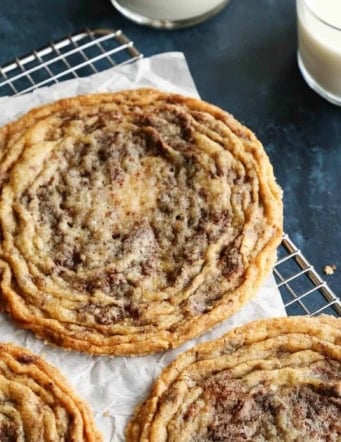 3 giant pan-banging chocolate chip cookies on a cooling rack